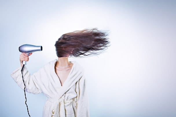 woman using hairdryer